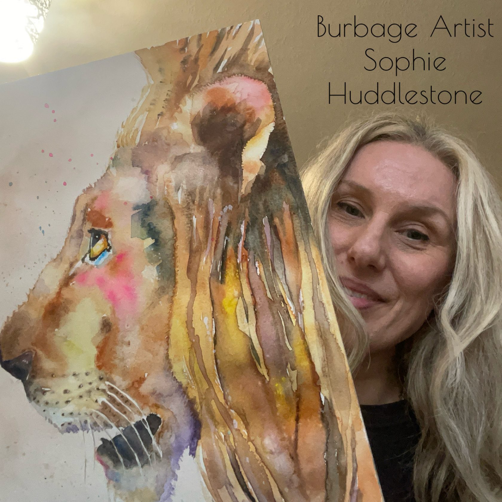 Sophie Huddlestone holding a lion painting she created in watercolours